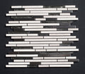 Mosaic tile pattern with black and white tiles on a dark background