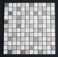 Square mosaic tile sample with gray and white tiles on a black background