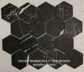 Hexagonal black marble tiles with white veins on a beige background