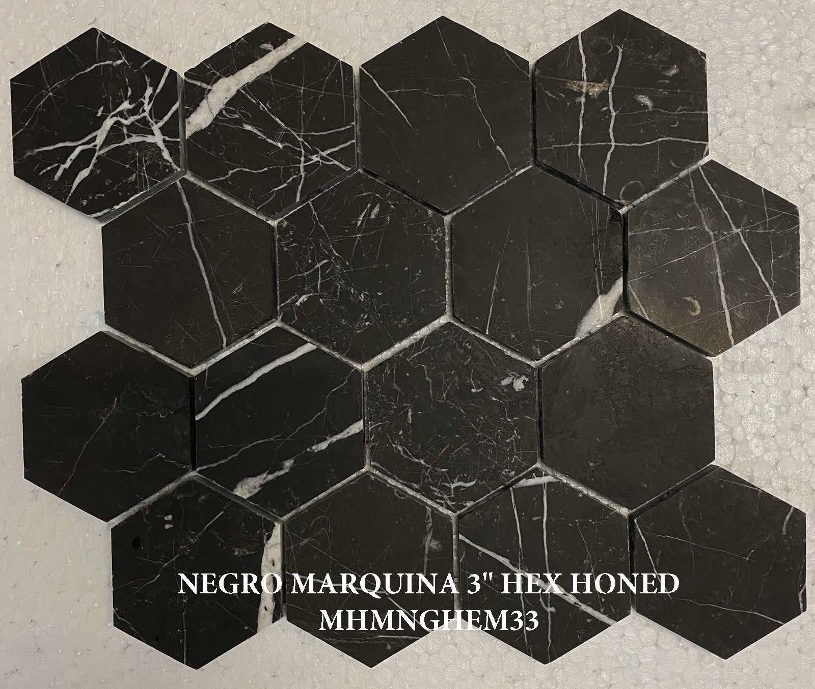 Hexagonal black marble tiles with white veins on a beige background