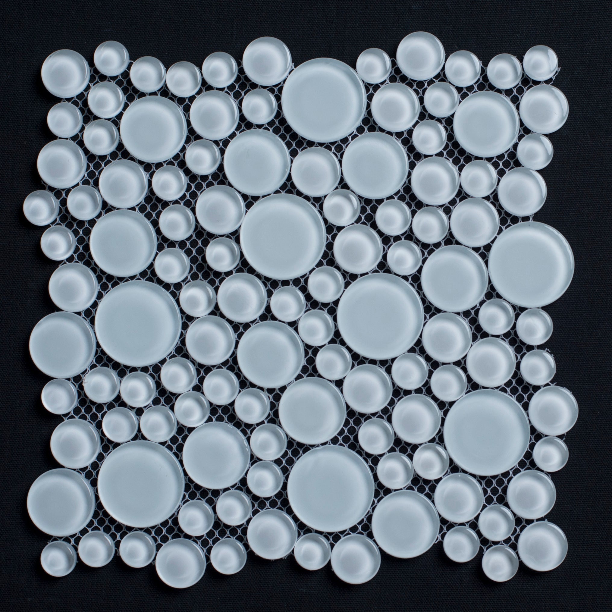 Mosaic pattern of white circular tiles