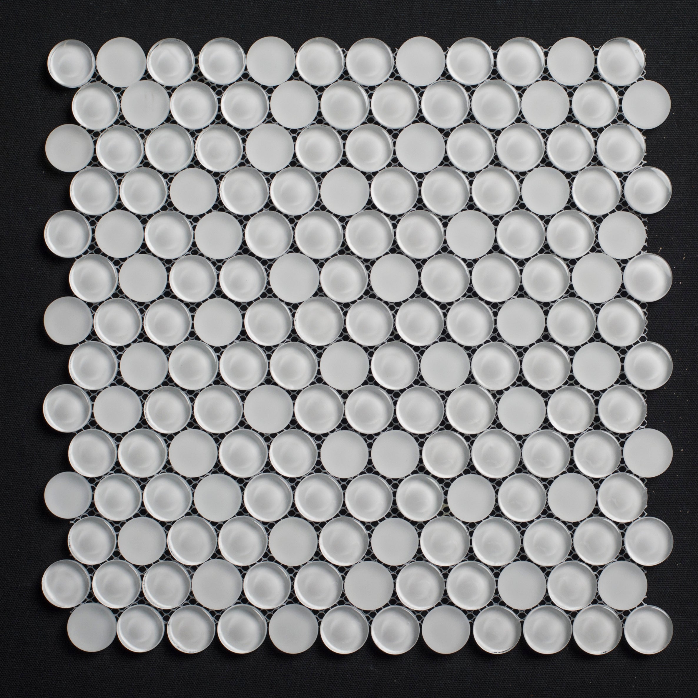 White circular tiles arranged in a grid pattern on a black background