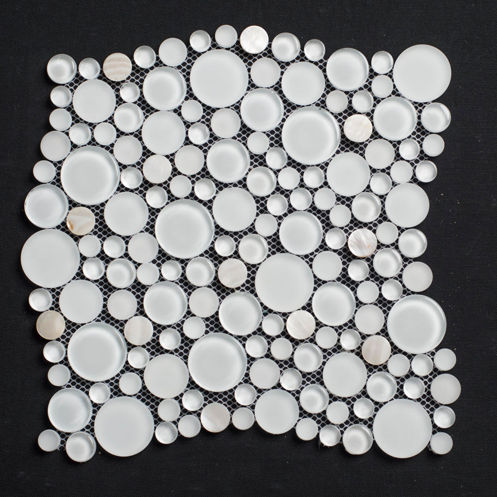 Mosaic tile with circular white stones on a black background
