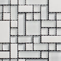 Mosaic pattern of black and white tiles on a white background