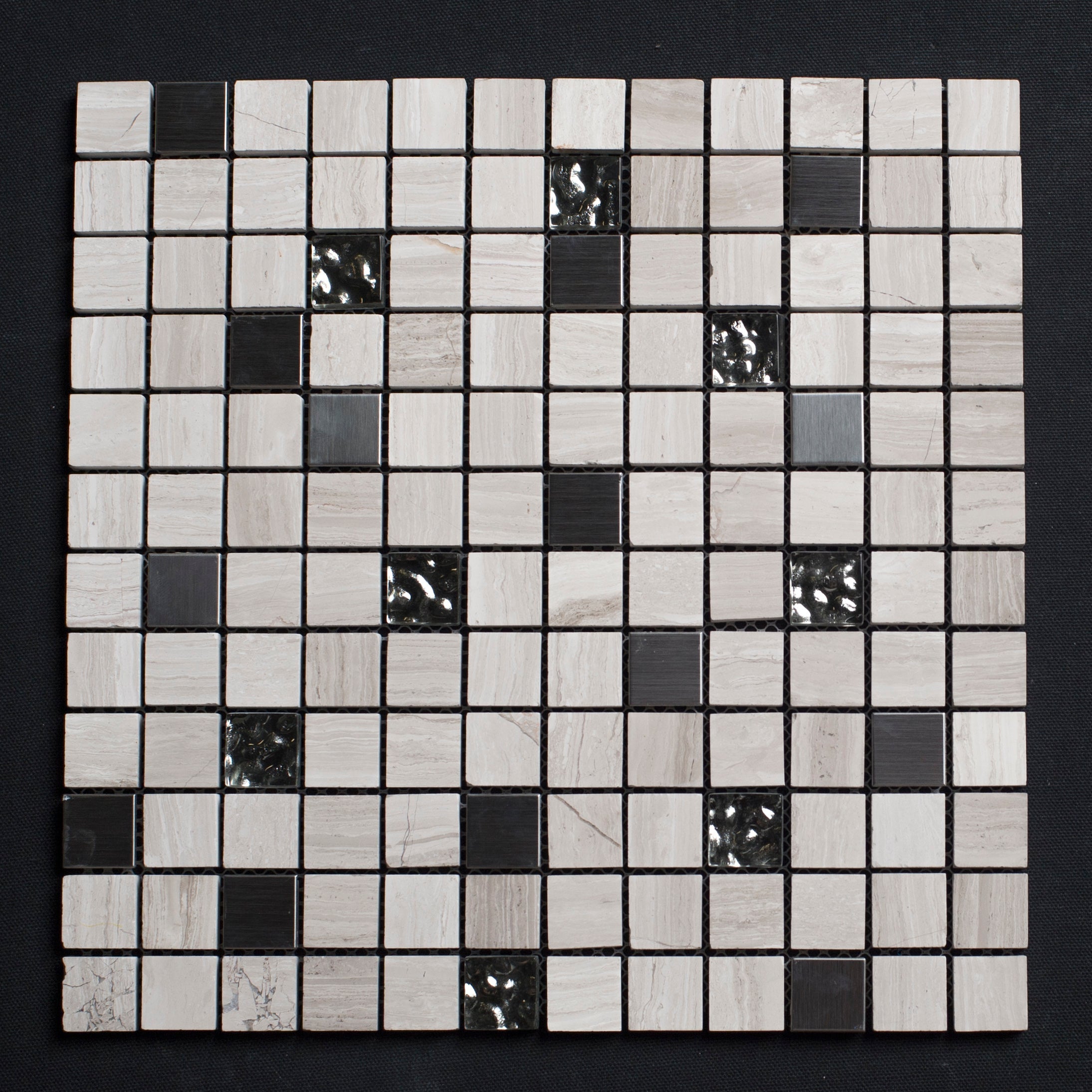 Mosaic tile sample with black and white squares on a dark background