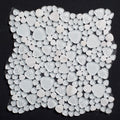 White pebble mosaic tile on a black background
