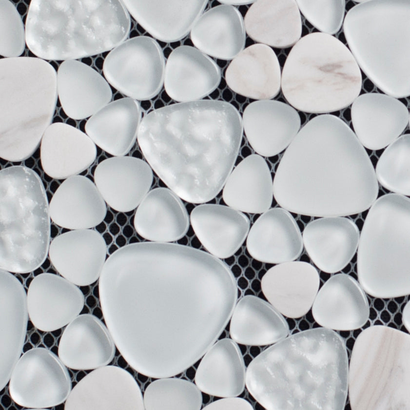 Close-up of white pebble mosaic tiles on a black grid background