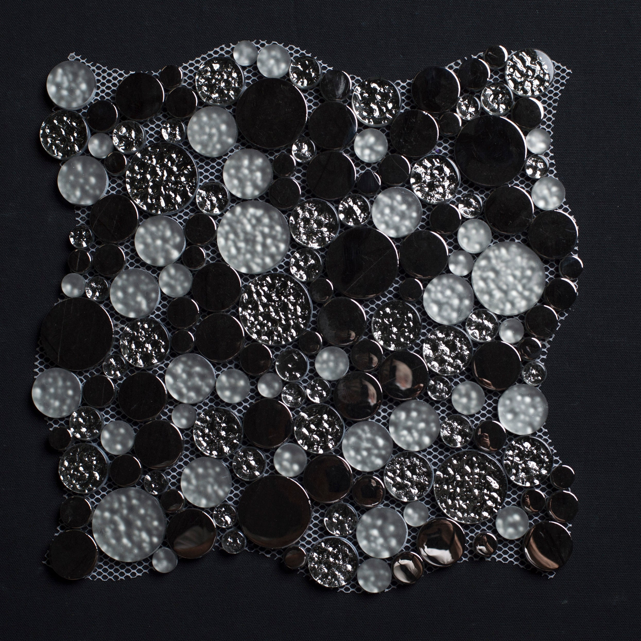 Black and silver sequin fabric on a black background