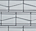 Mosaic pattern of rectangular tiles with black grout lines on a white background