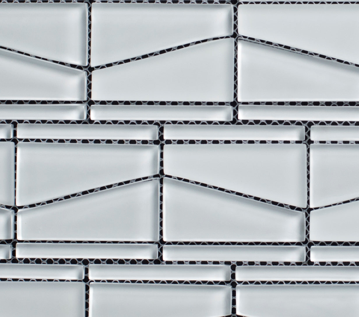 Mosaic pattern of rectangular tiles with black grout lines on a white background