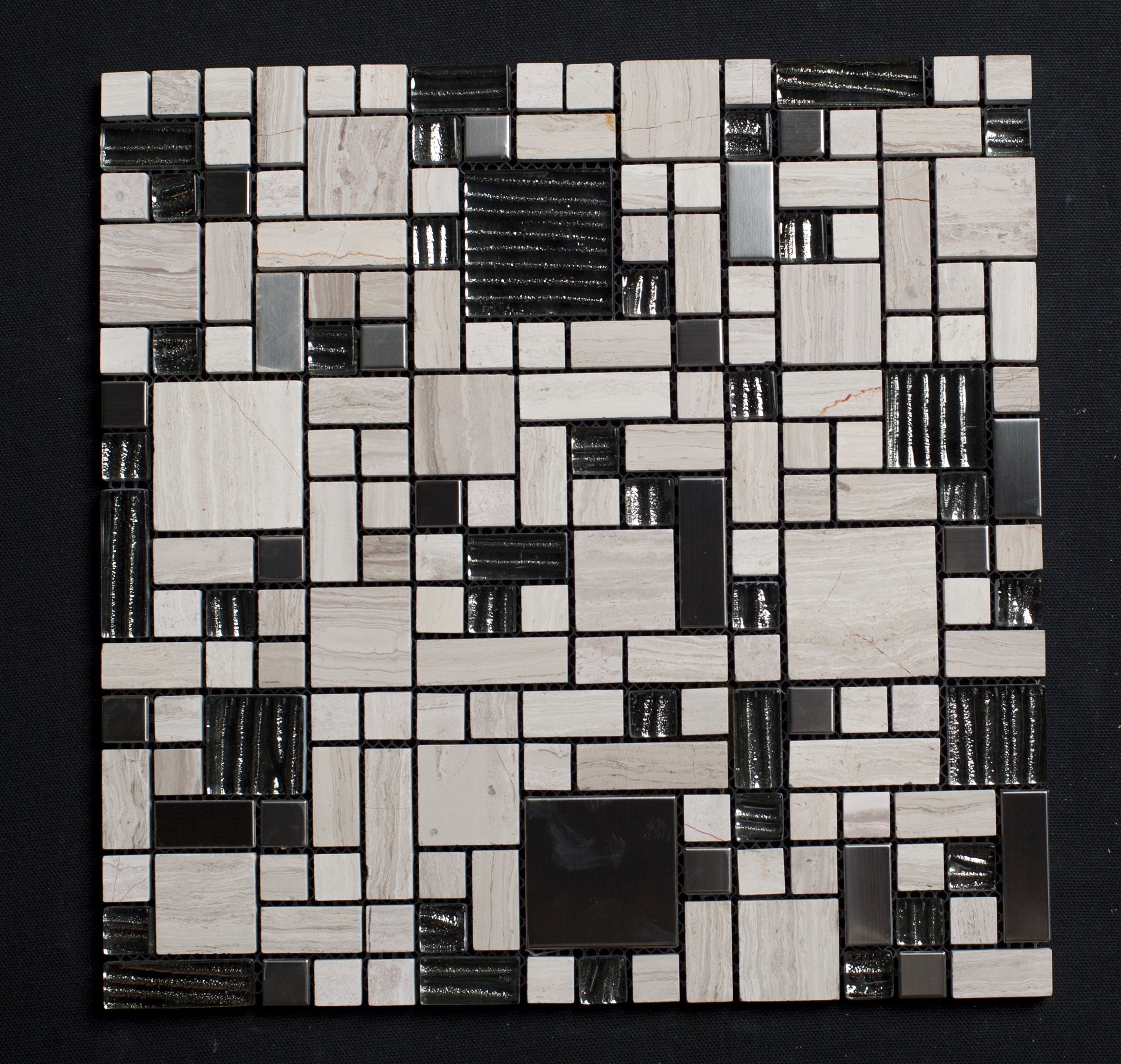 Mosaic pattern of black, white, and gray tiles on a dark background