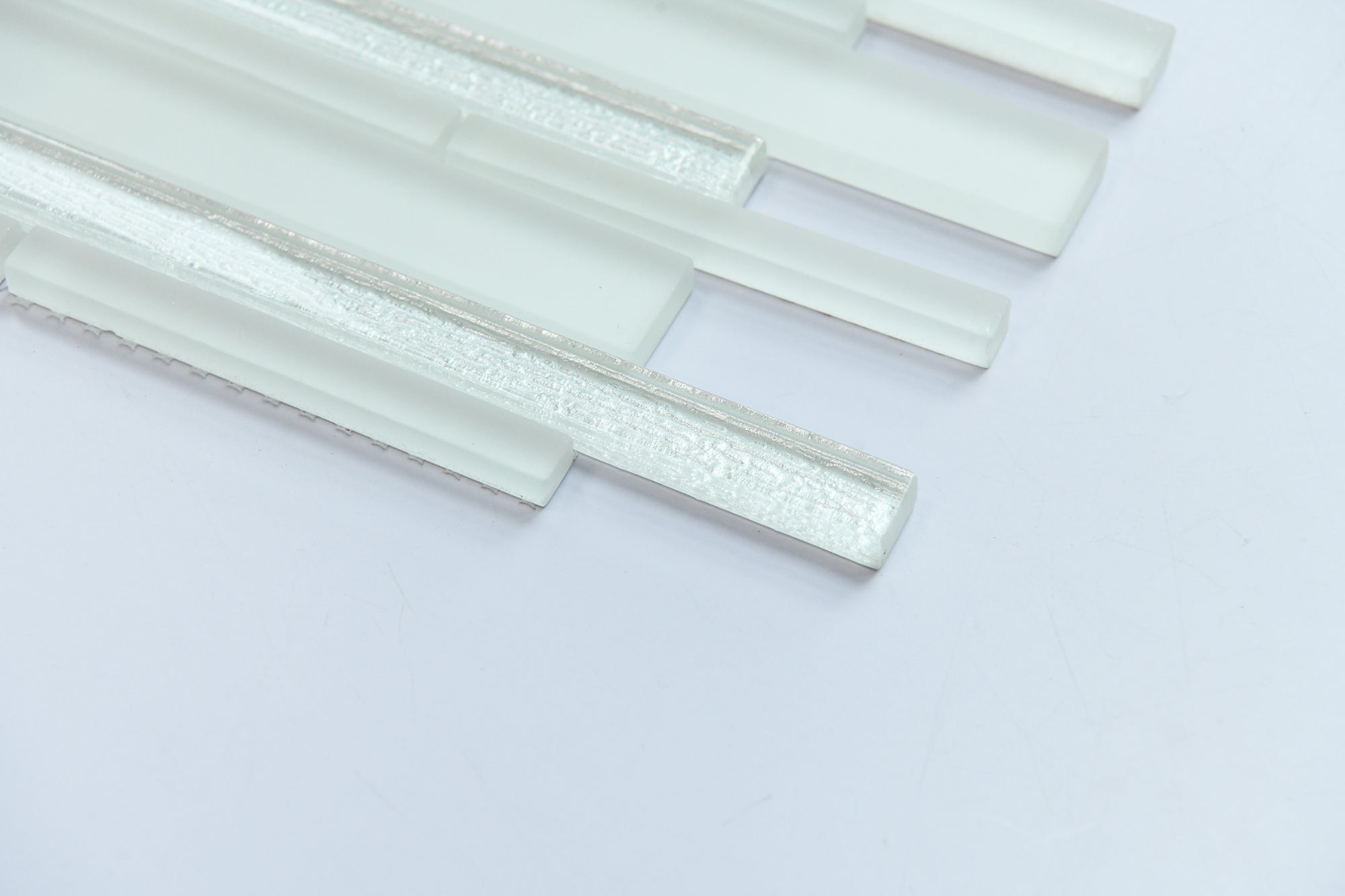 White glass mosaic tiles on a light gray background