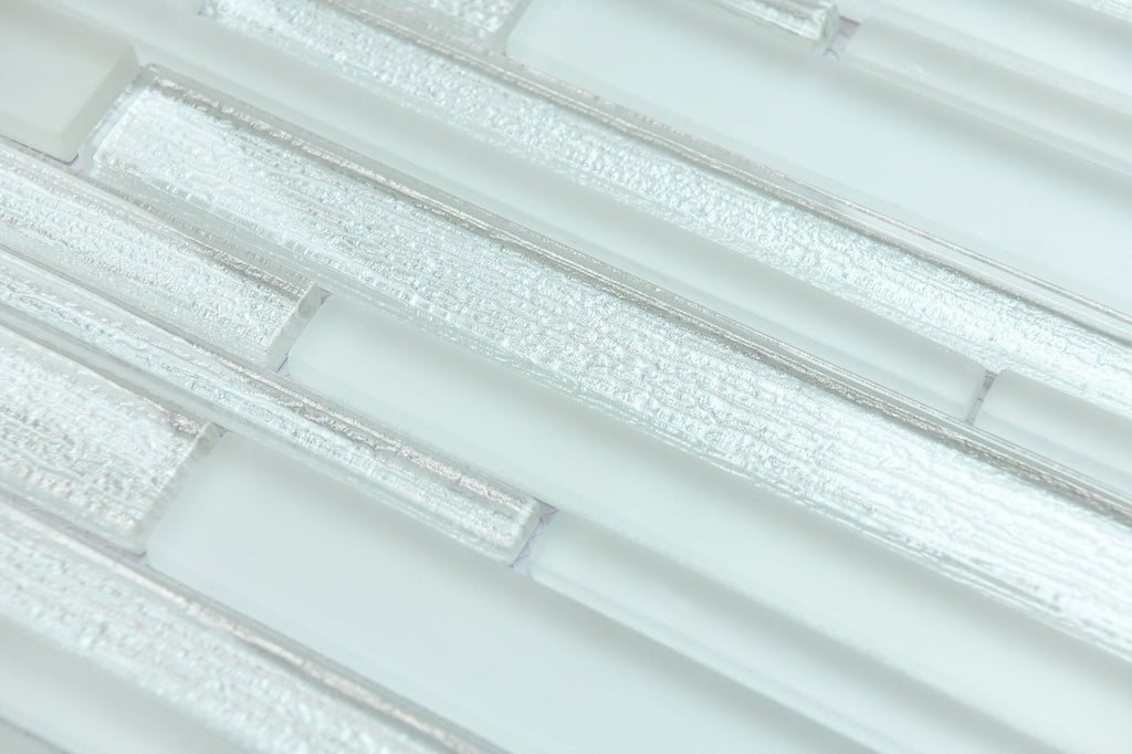 Close-up of light gray glass mosaic tiles with a subtle pattern