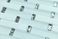 Close-up of small rectangular metallic objects on a white background