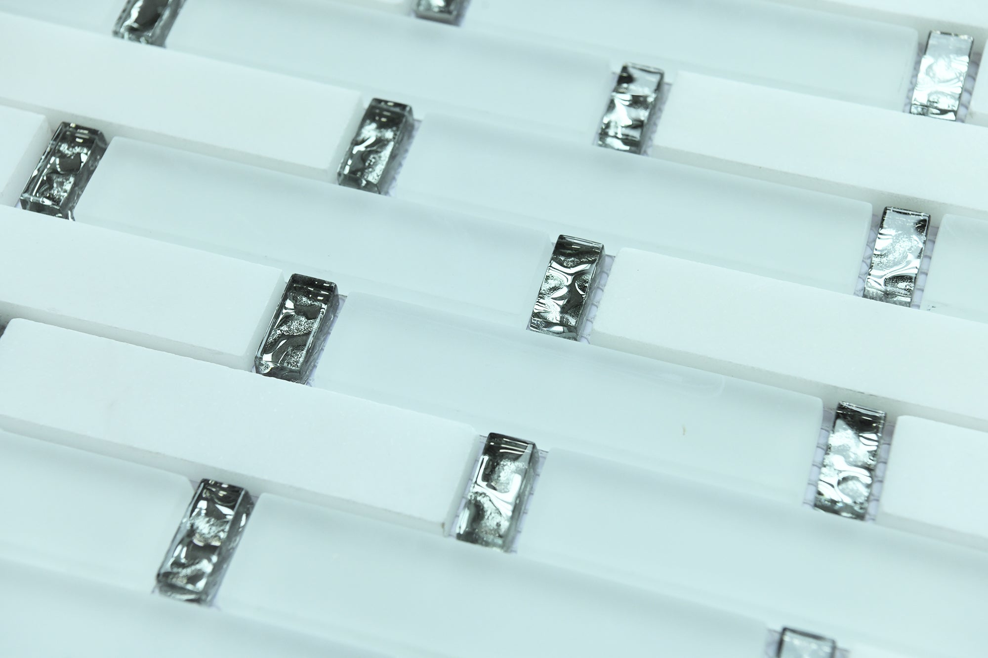 Close-up of small rectangular metallic objects on a white background