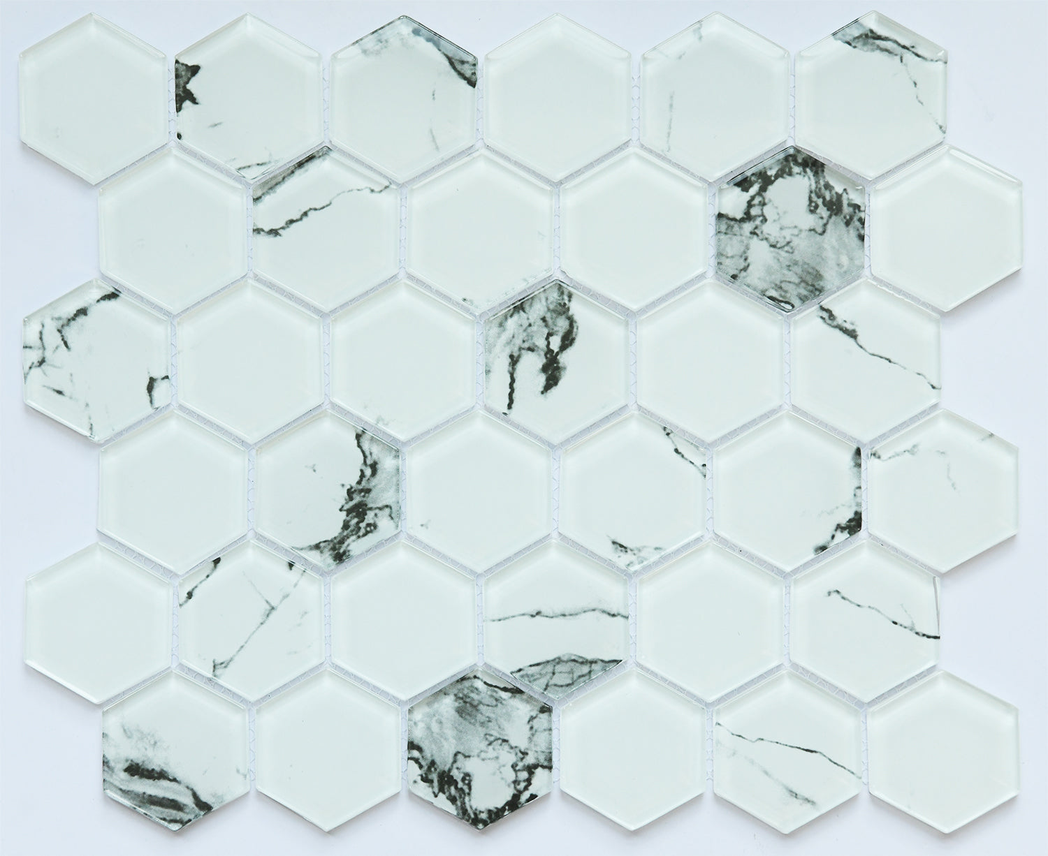 Hexagonal marble mosaic tiles with a white and gray pattern on a light gray background