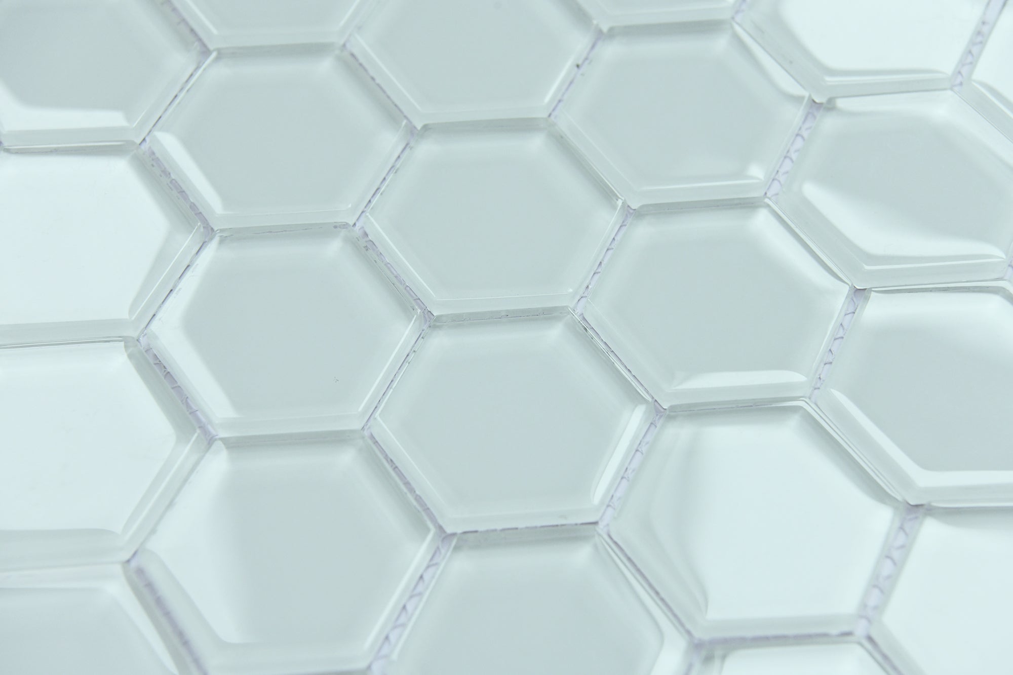 Close-up of hexagonal white tiles with a subtle pattern