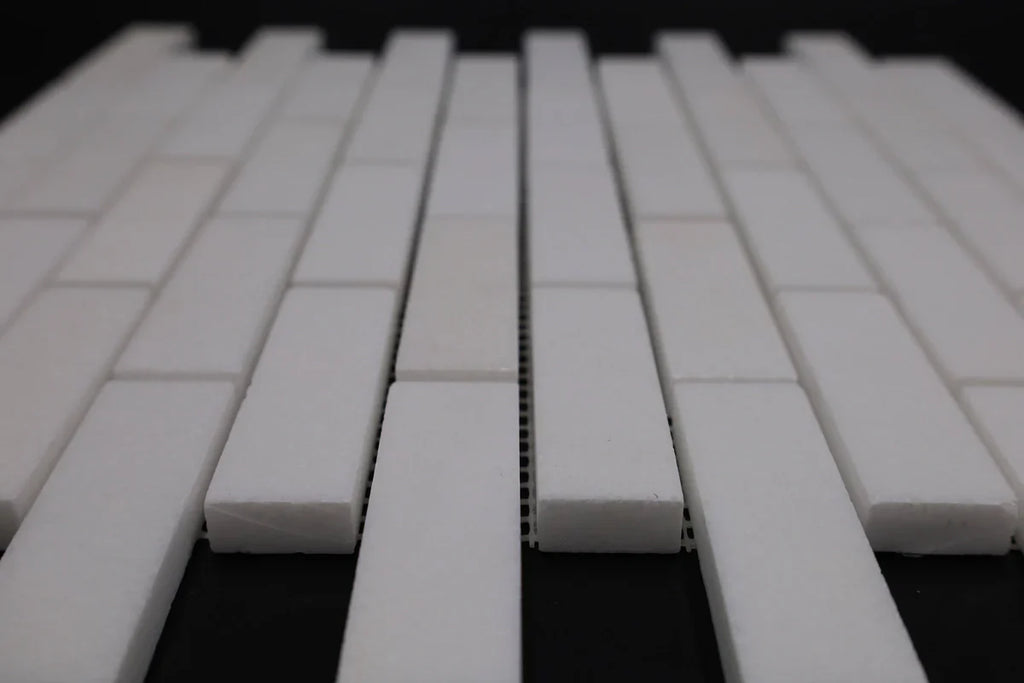 White ceramic tiles arranged in a pattern on a dark background