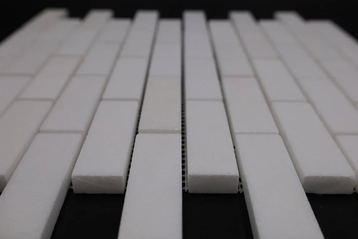 White ceramic tiles arranged in a pattern on a dark background
