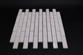 White ceramic mosaic tiles on a black background